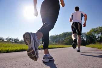 Young couple jogging in park at morning. Health and fitness.